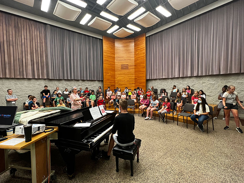Campers and staff practicing in a music room