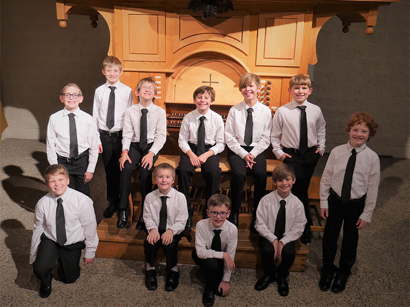Training choir in matching white shirts and black ties
